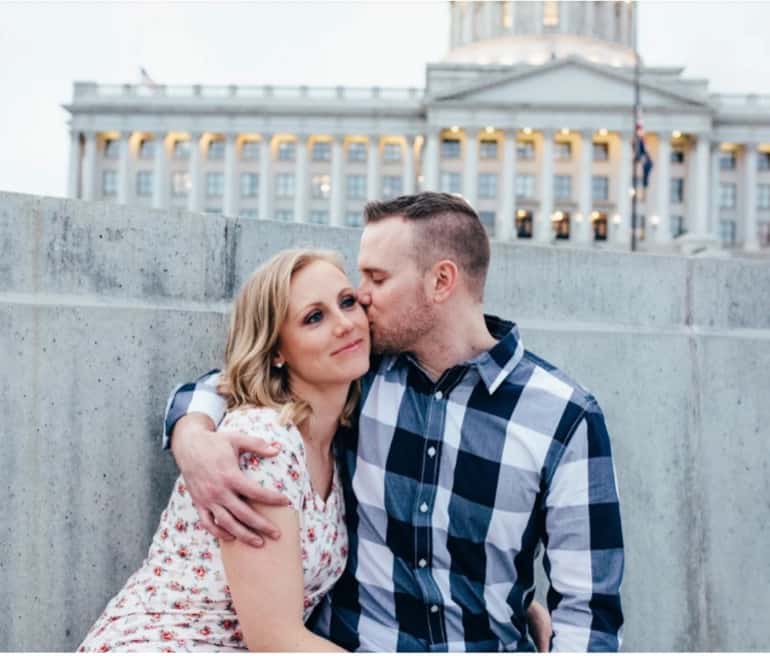 Man kissing woman outside State Capitol of Salt Lake City