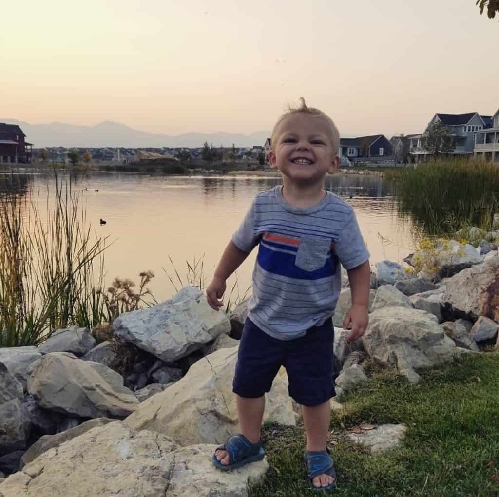 Little boy at pond smiling  at dusk, salt Lake City