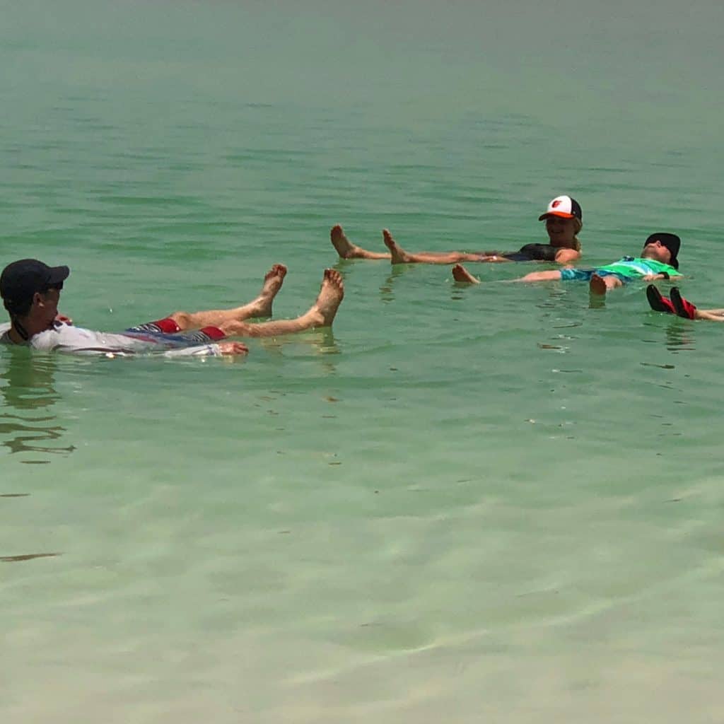 Family floating in the dead sea, Israel