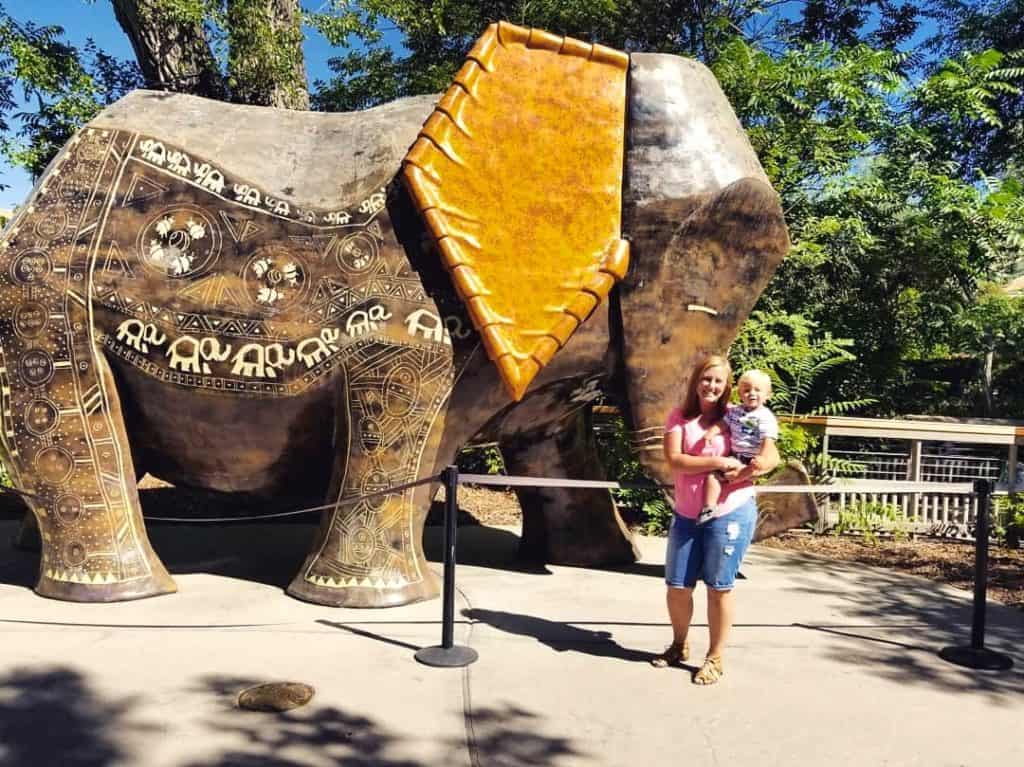 Mom and child standing in front of Elephant sculpture at Hogle Zoo Salt Lake City, Utah