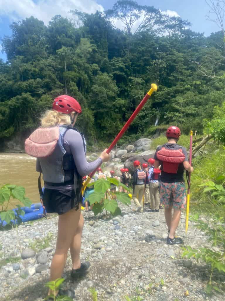 Walking with gear and oar to go what water rafting in Boquete Panama